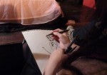 Molly Crabapple hard at work...