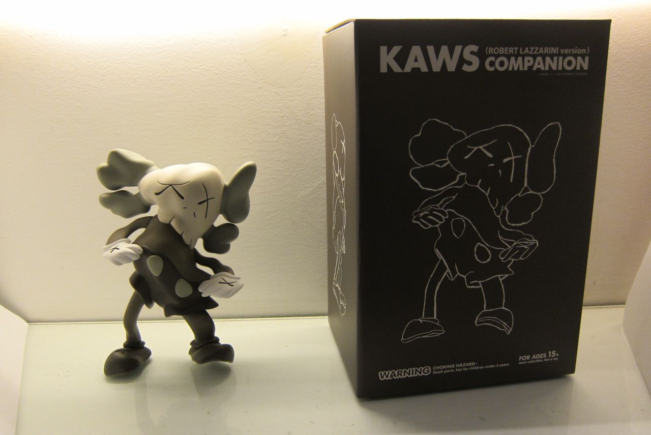 Details: KAWS x Robert Lazzarini – “Distorted Companions